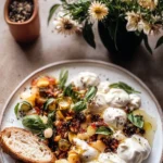 Smashed Burrata with Jam and Pistachios on White Plate